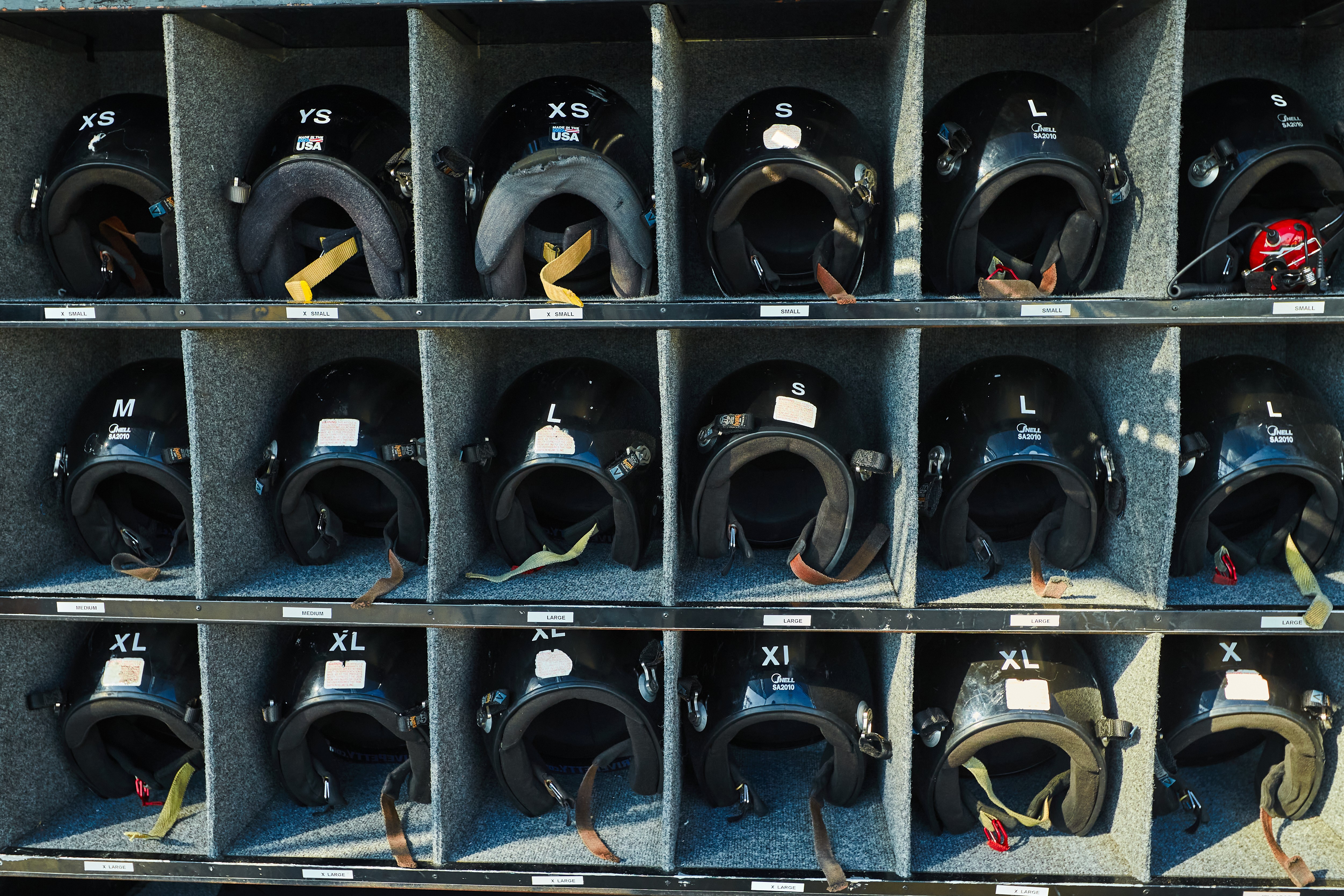 Driver helmets close-up for Audemars Piguet VIP guests in Florida driving on Daytona track – luxury event photography.