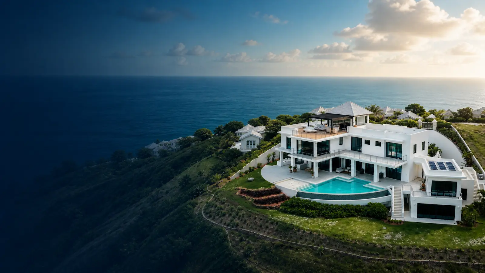 Aerial view of the Devaux Residence, a modern luxury home with infinity pool designed by Atelier International on a cliffside in Saint Lucia overlooking the Caribbean Sea
