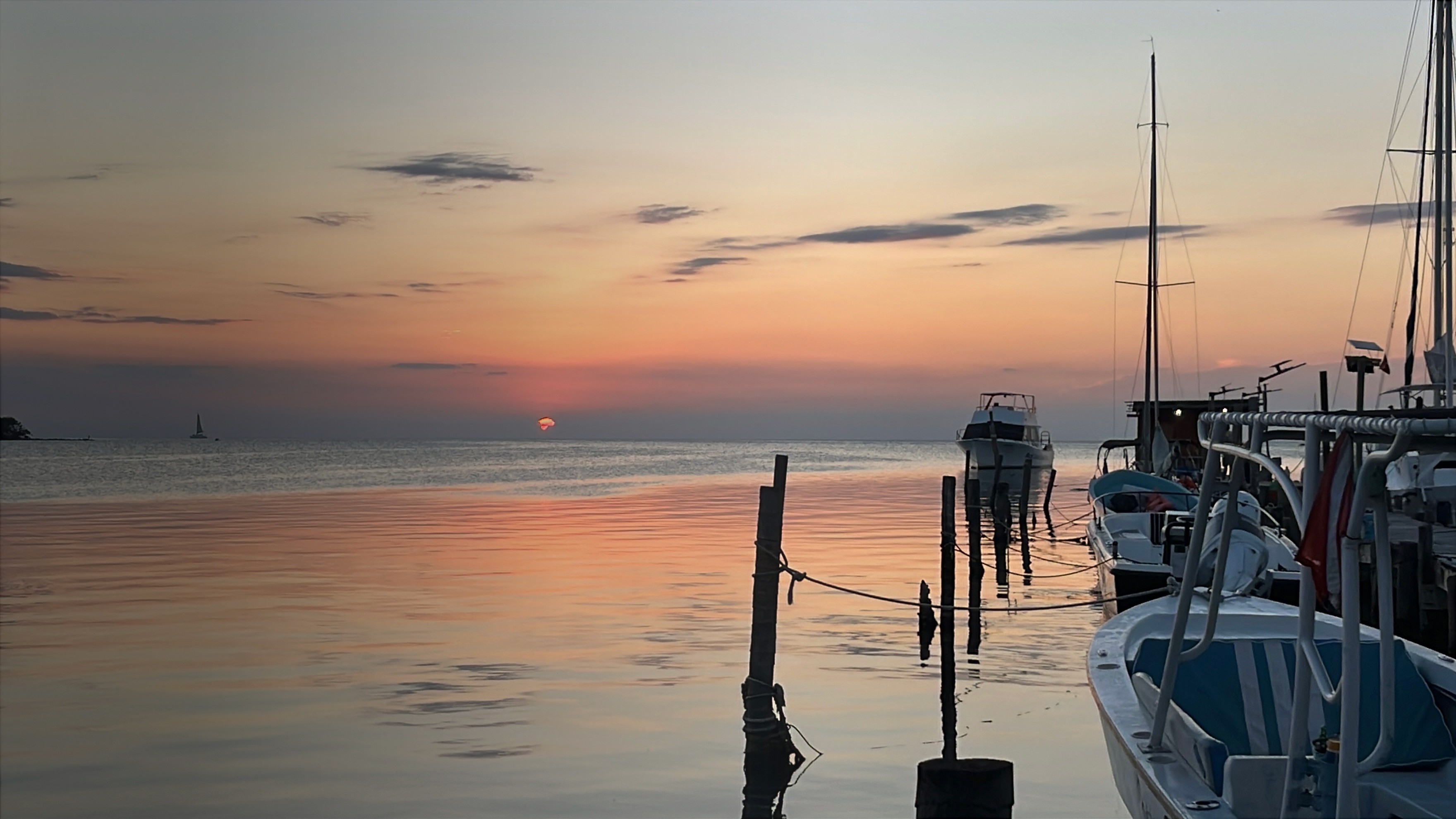 Sunset on ocean with boat docked