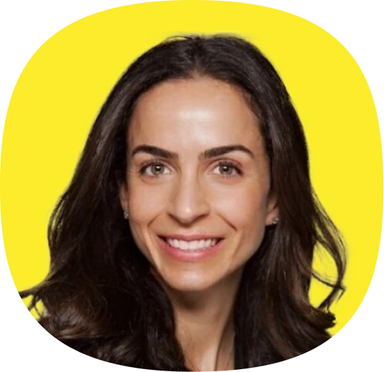 A woman with long dark hair and fair skin smiles at the camera, set against a bright yellow background, highlighting the vibrant energy of Kustomer Winter Quarterly AI Innovations.