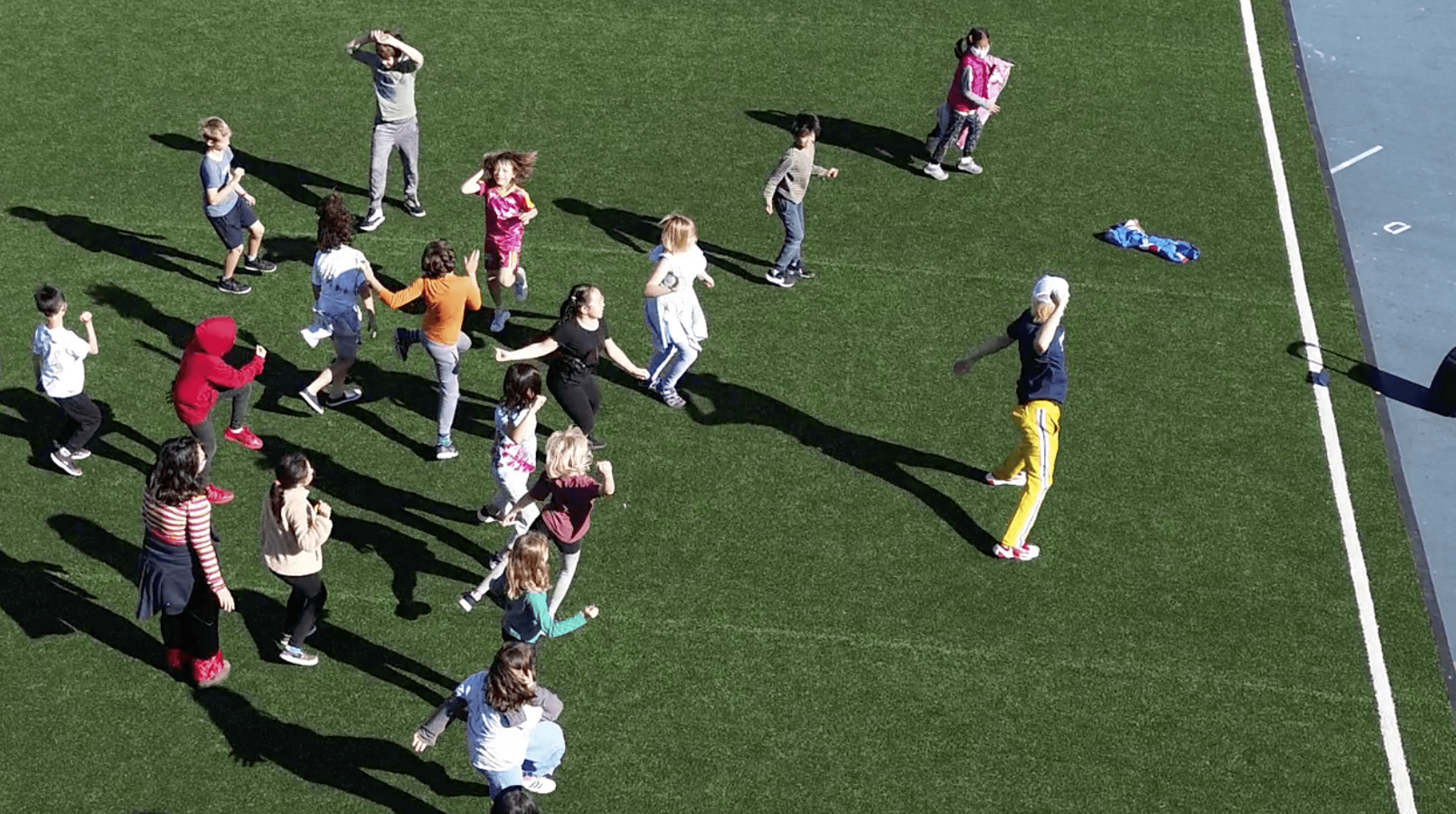 elementary students playing outdoor games during a HOKALI after-school sports and physical activity program on a school field
