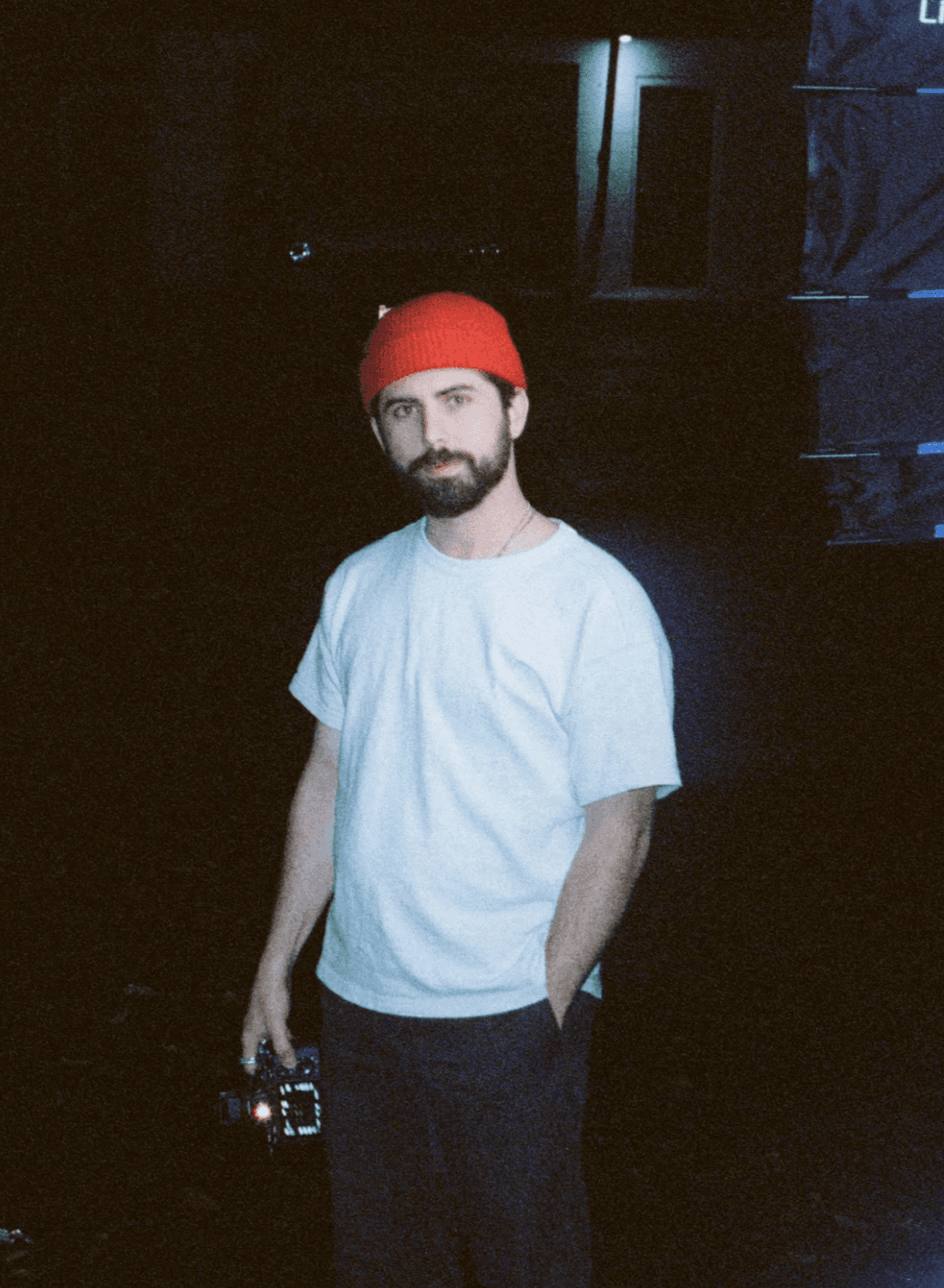 Portrait of a person in a pink sweater against a light background