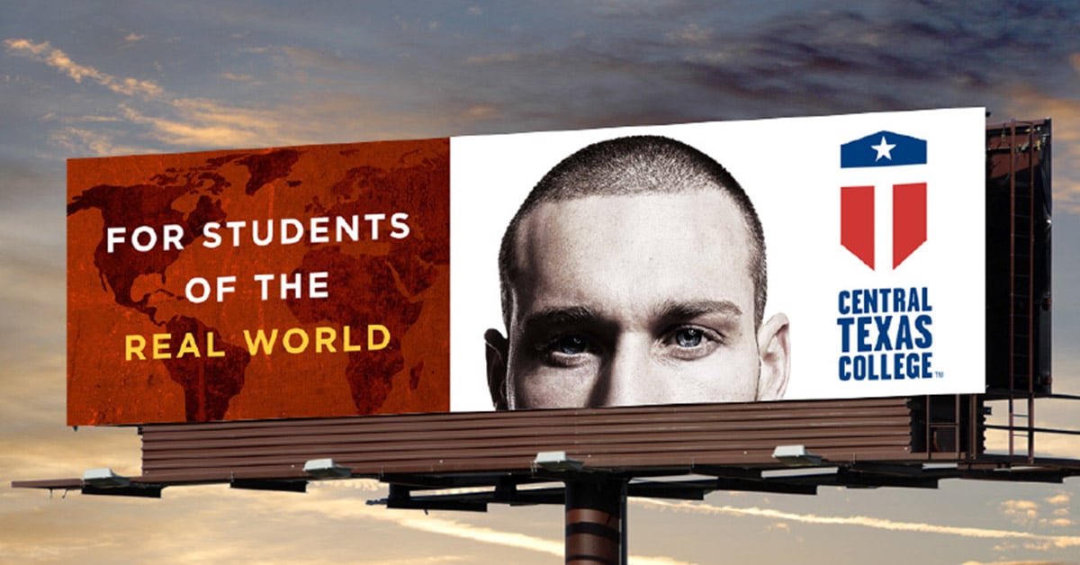 a man walking down a street past a large poster