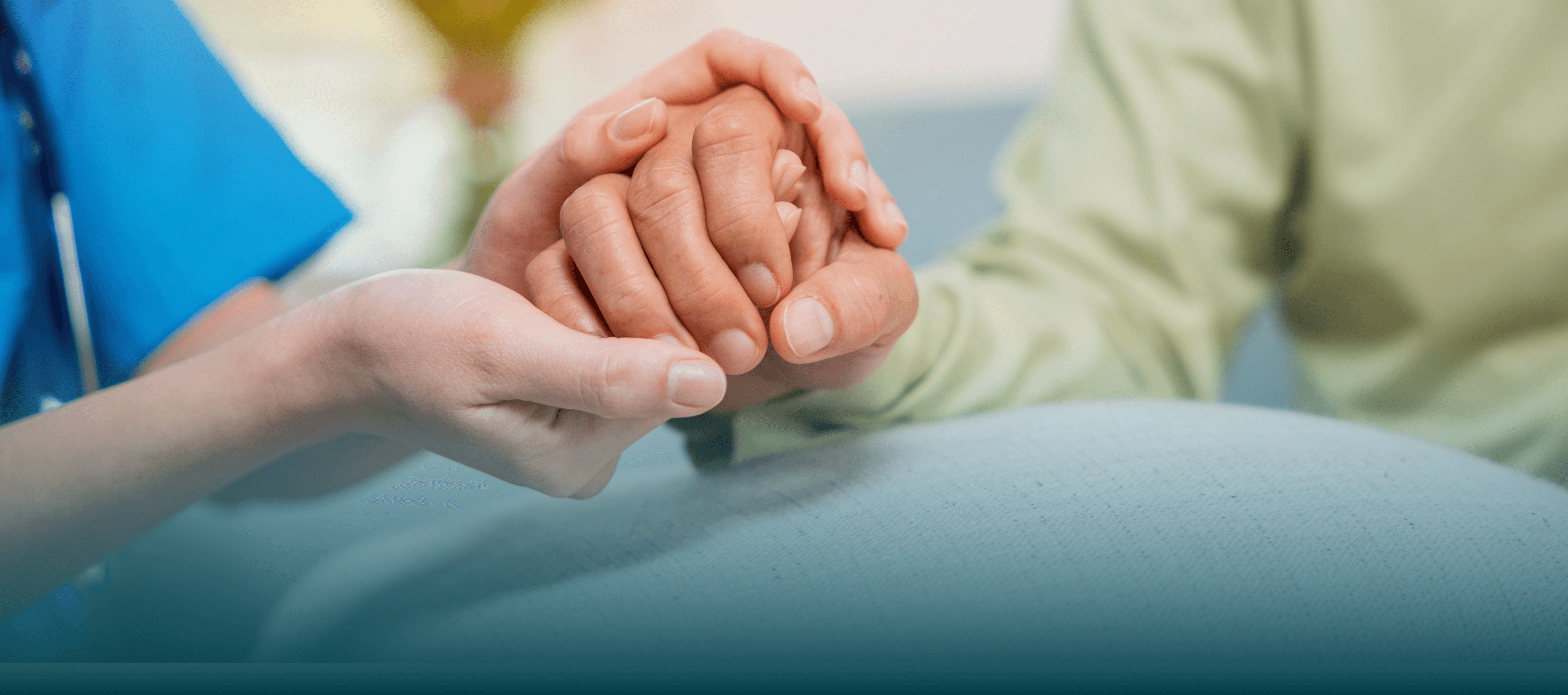 Caregiver holding an elderly person's hand, symbolizing compassionate home care support.