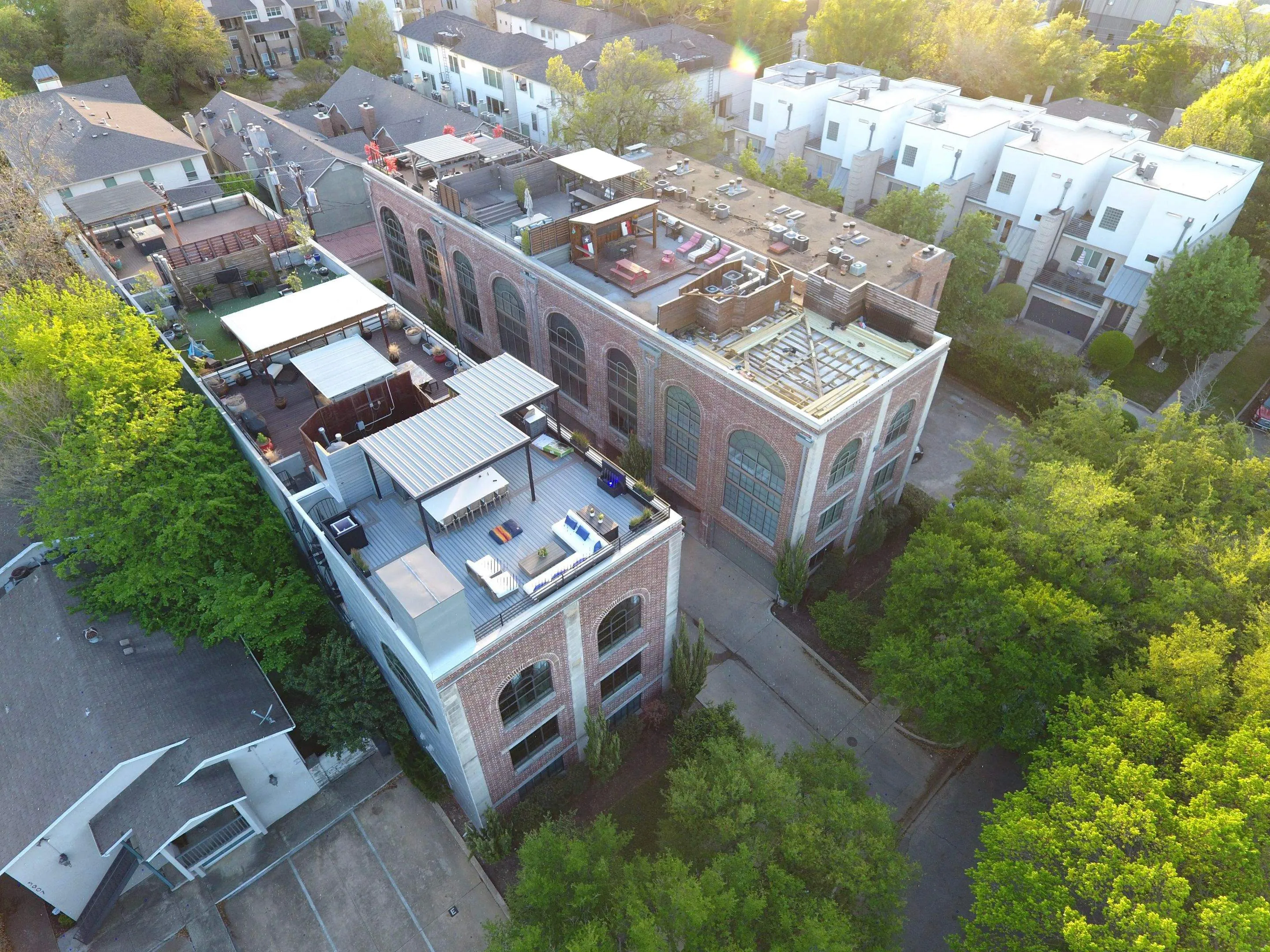 Full aerial view of Oak Lawn townhomes with rooftop decks and residential flat roofing systems in Dallas TX