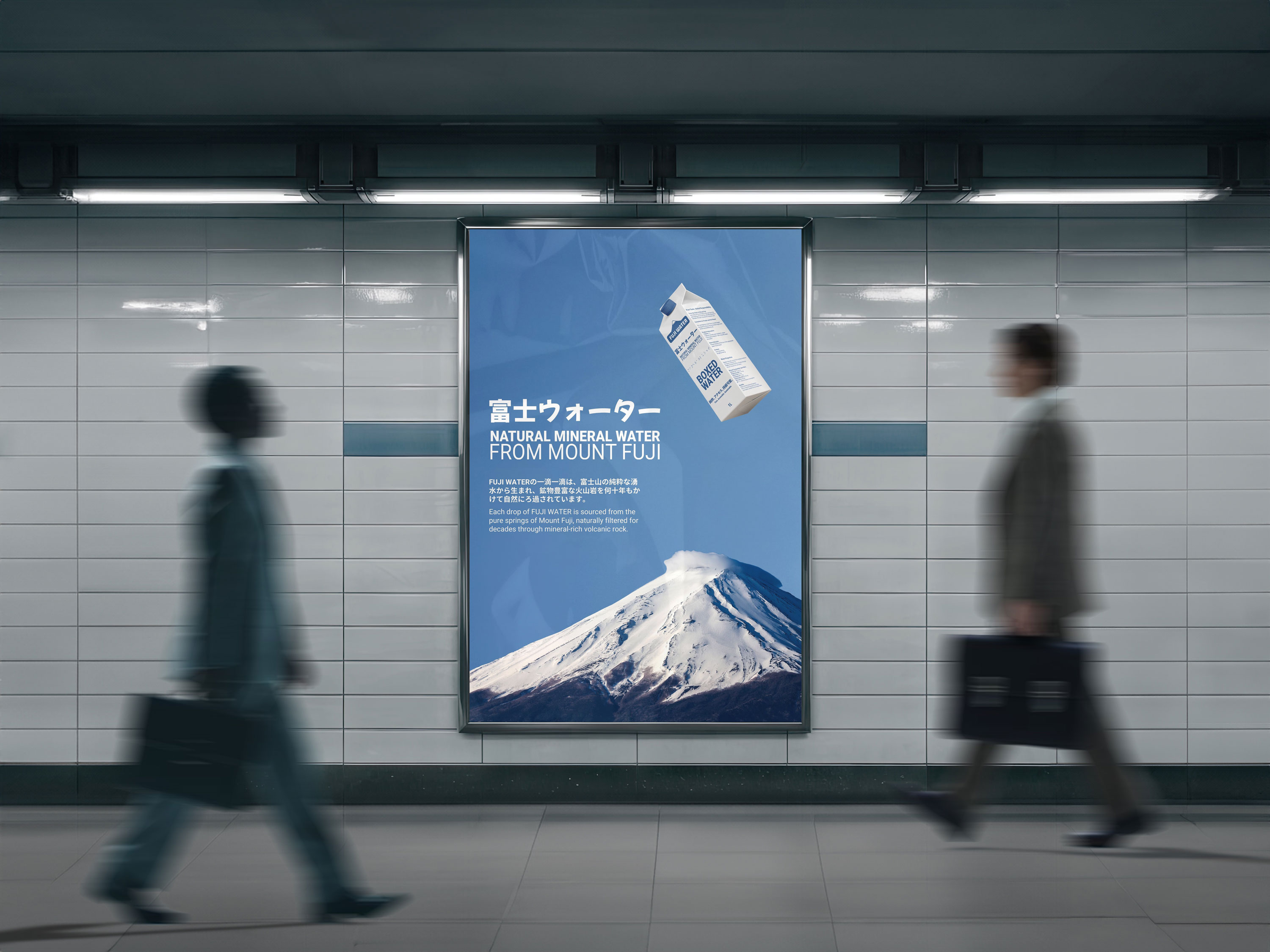 Two people in business attire walk past a large advertisement featuring Mount Fuji in a subway station.