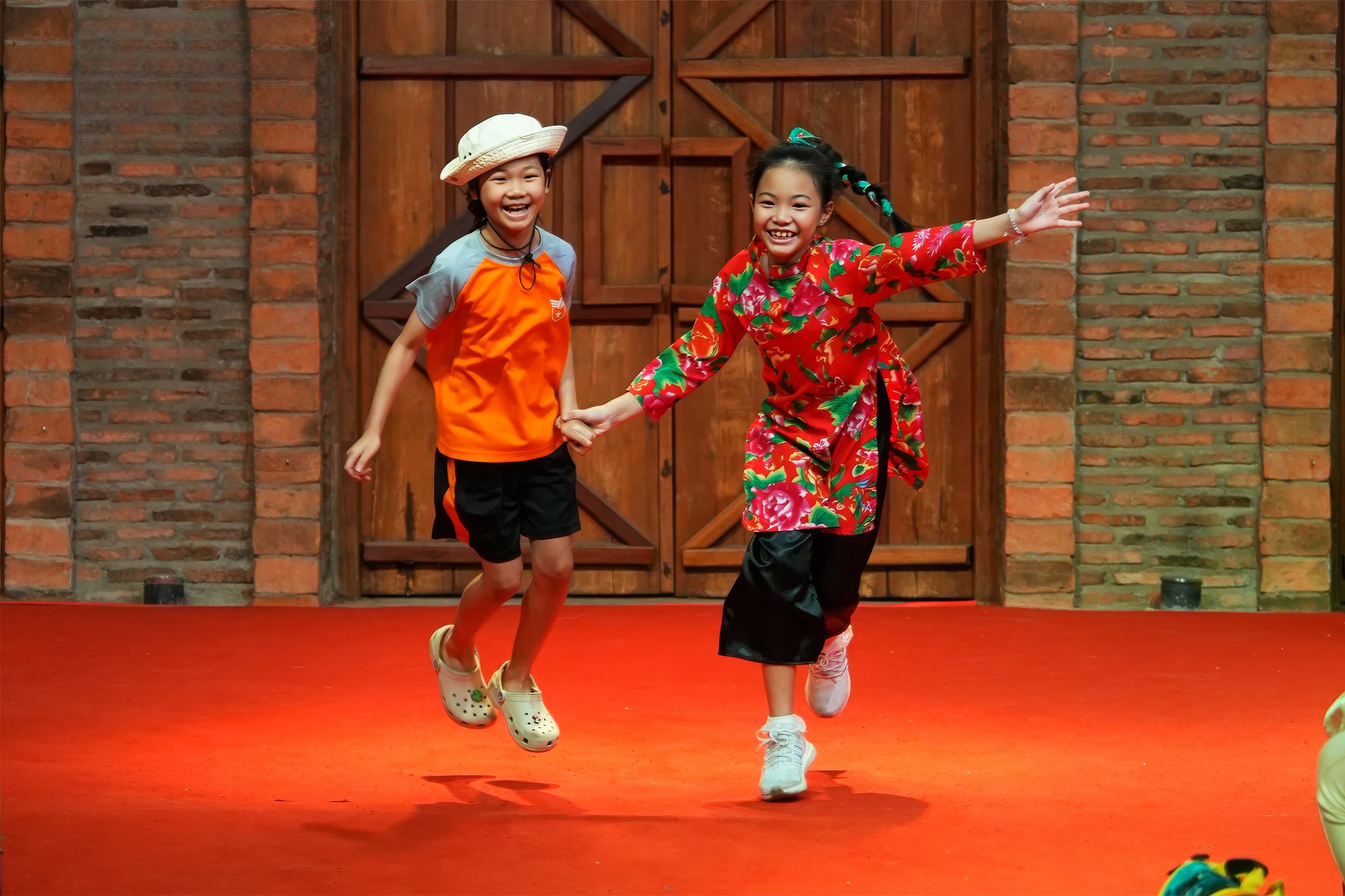A close-up of a beige-colored laptop with a smooth, matte finish on a matching surface.