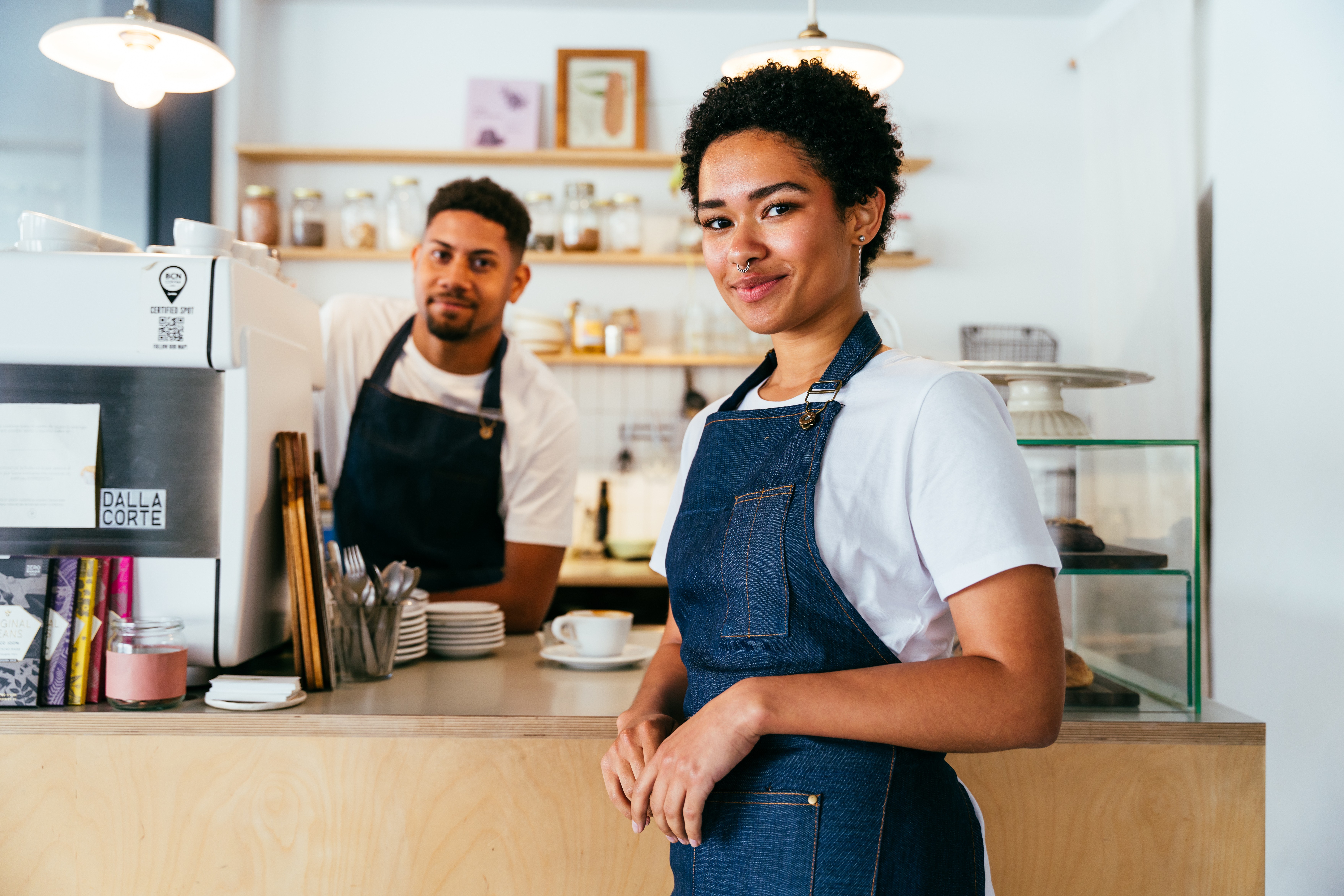 A maroon passport, a credit card, and a document are placed on a dark surface.