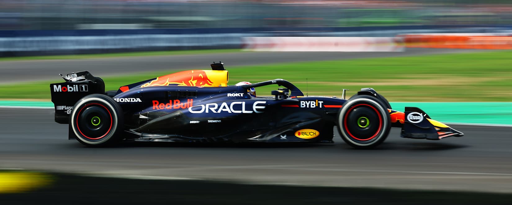 a red and yellow race car driving down a race track