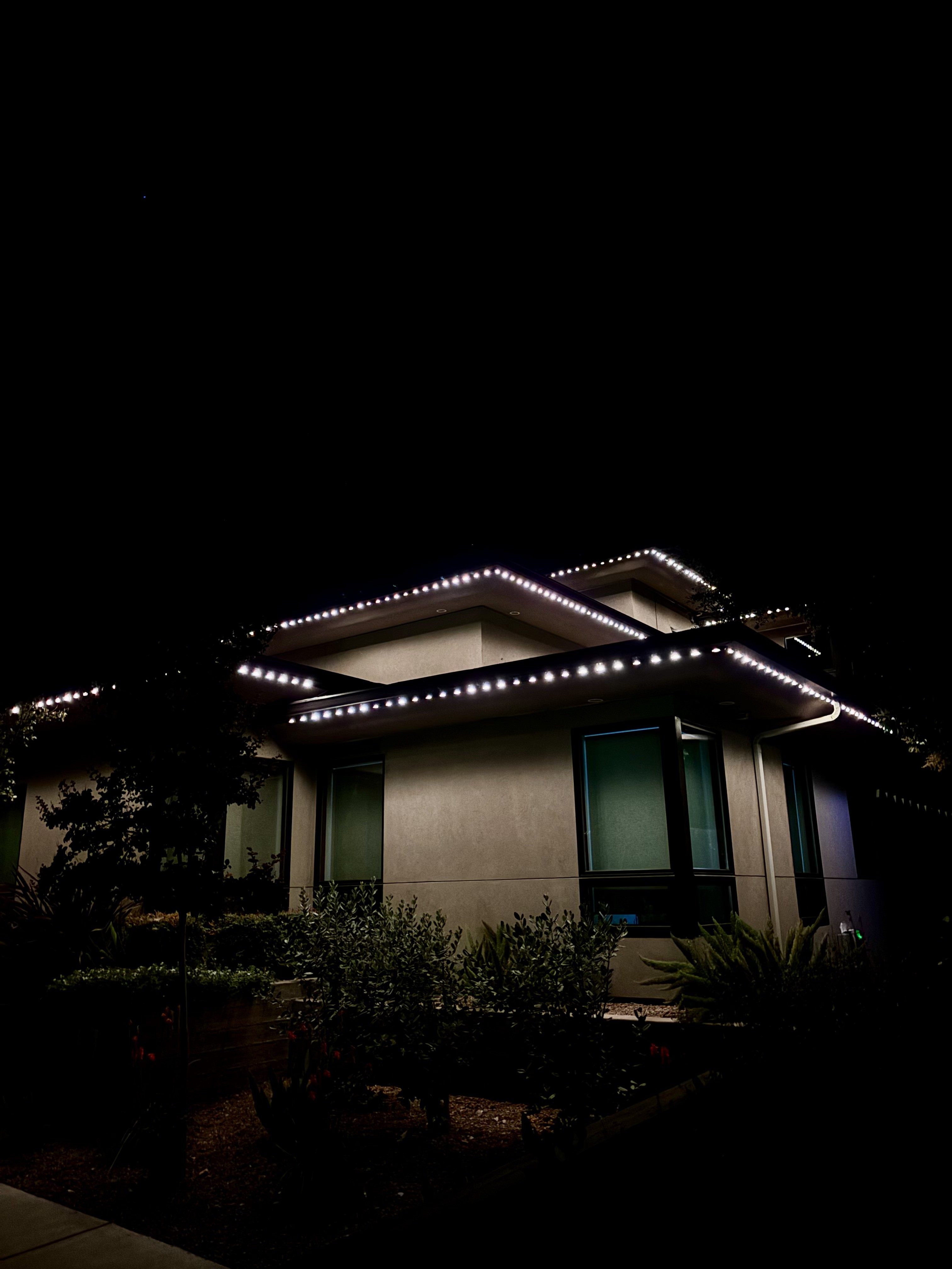 Multi-level commercial property illuminated with permanent roofline lighting
