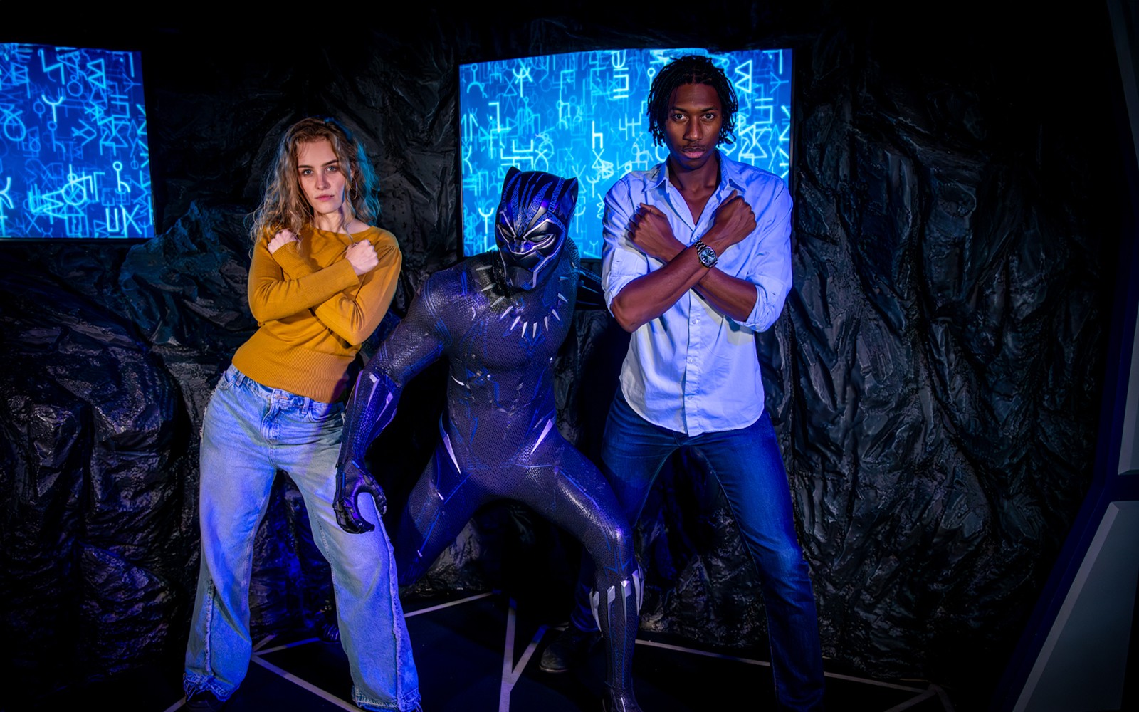 Black Panther wax figure at Madame Tussauds London with visitors taking photos.