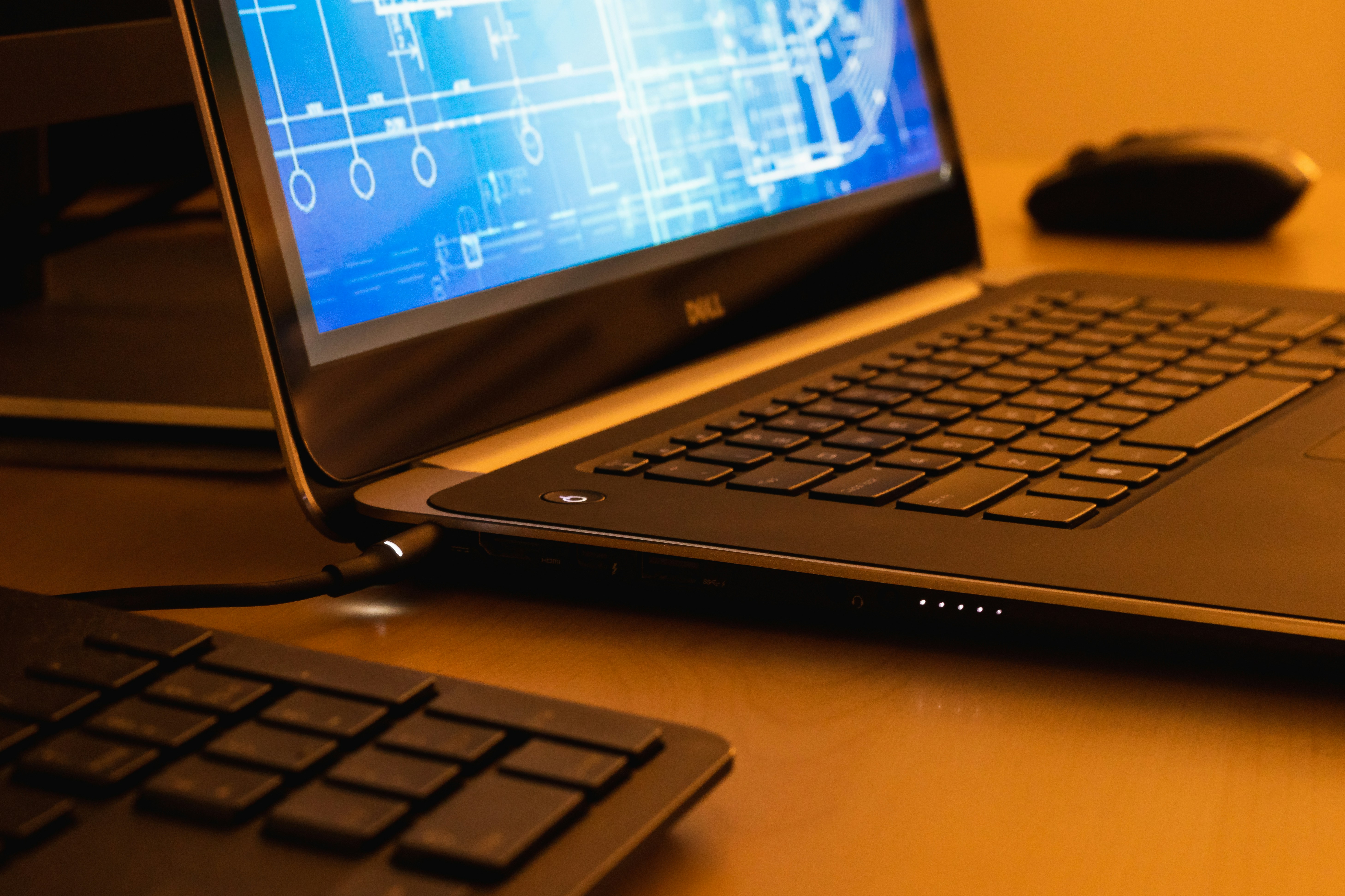 Close-up of a laptop displaying a CAD drawing on screen