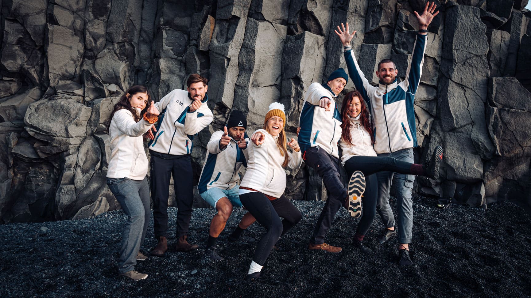 Playful photo of the Breathe and Flow team laughing in amongst the cliffs in Iceland.