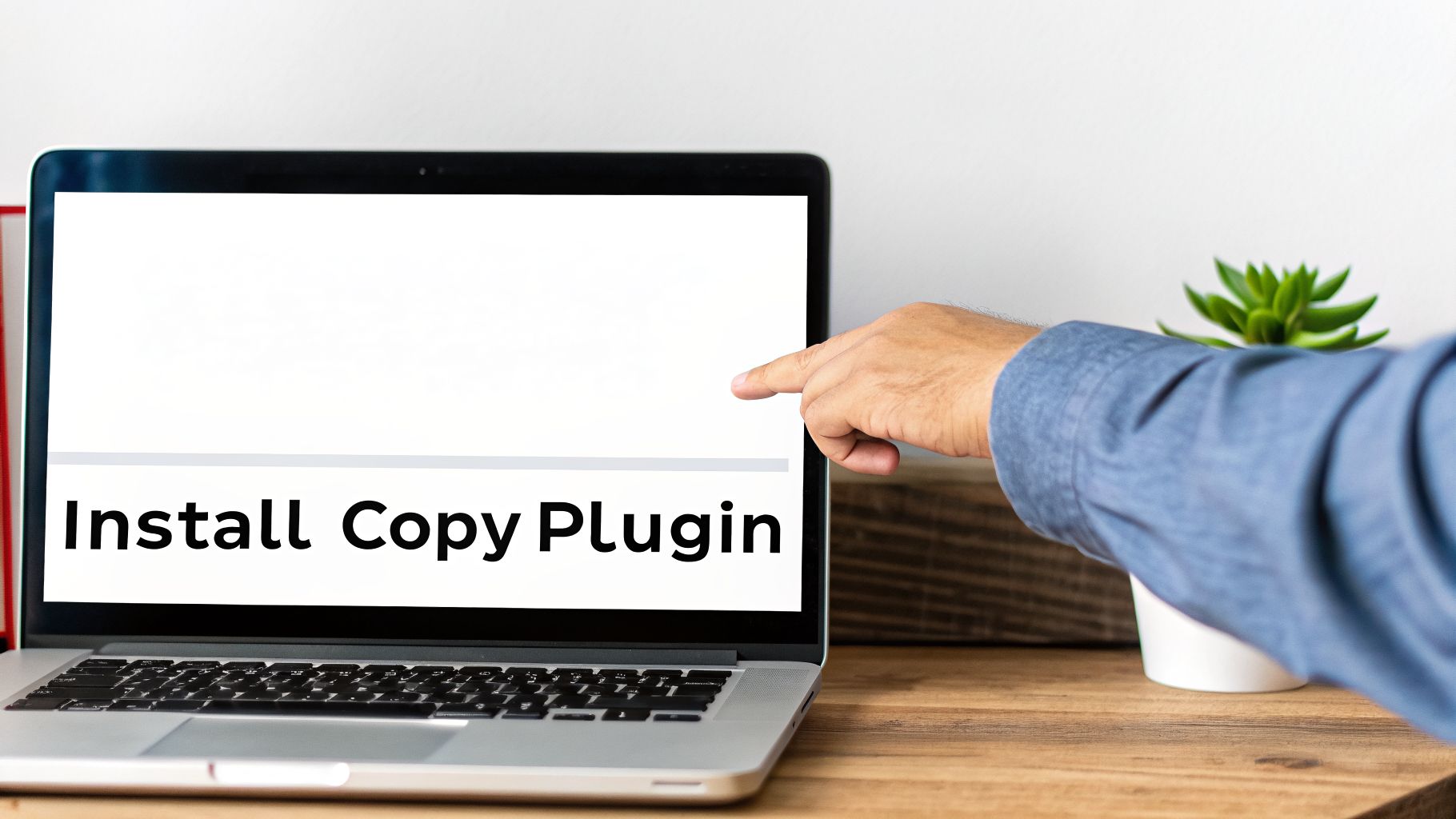 A person's hand points to a laptop screen displaying the text 