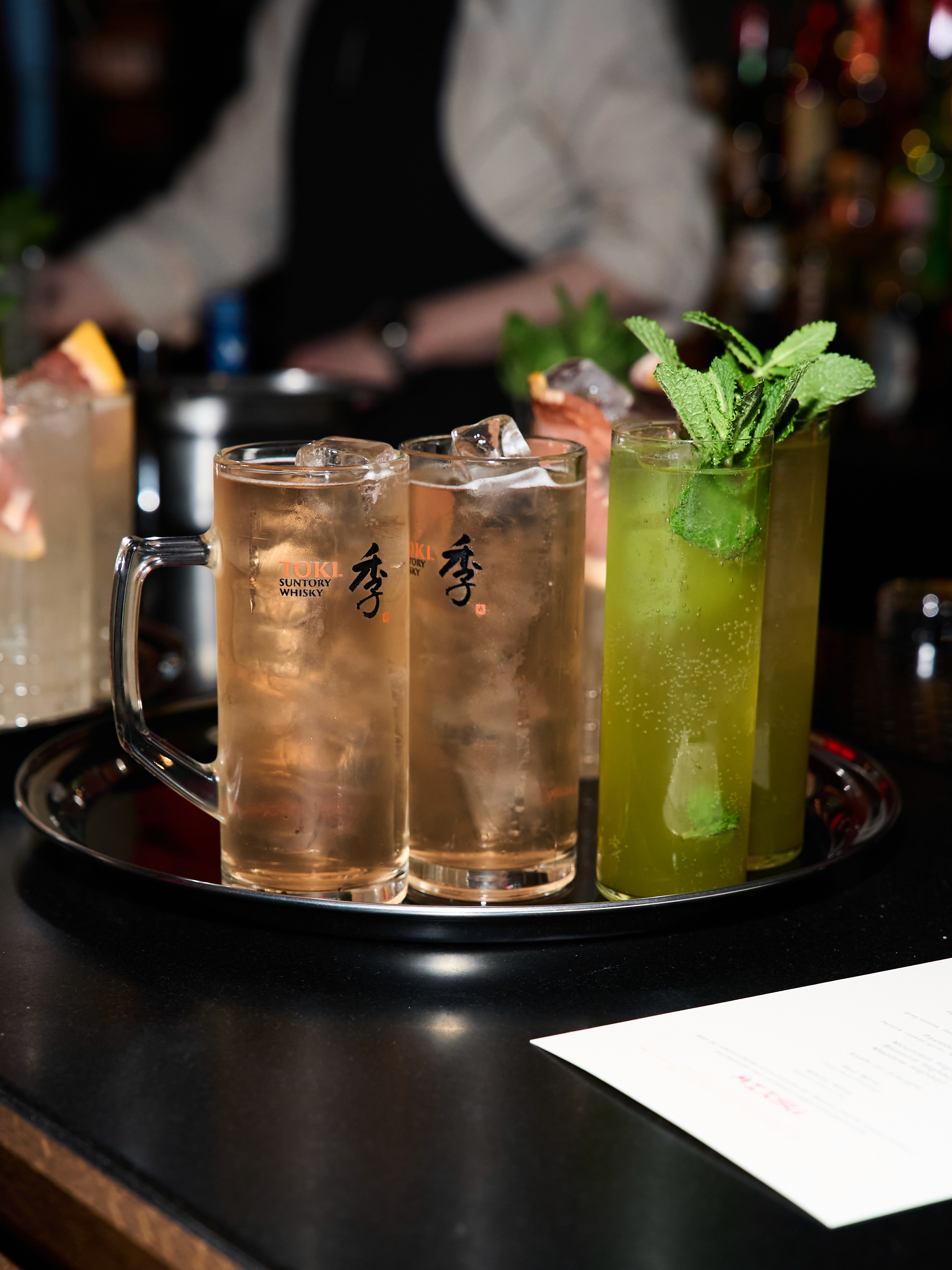 Tray of Suntory Toki Whisky Highballs and Mojito cocktails