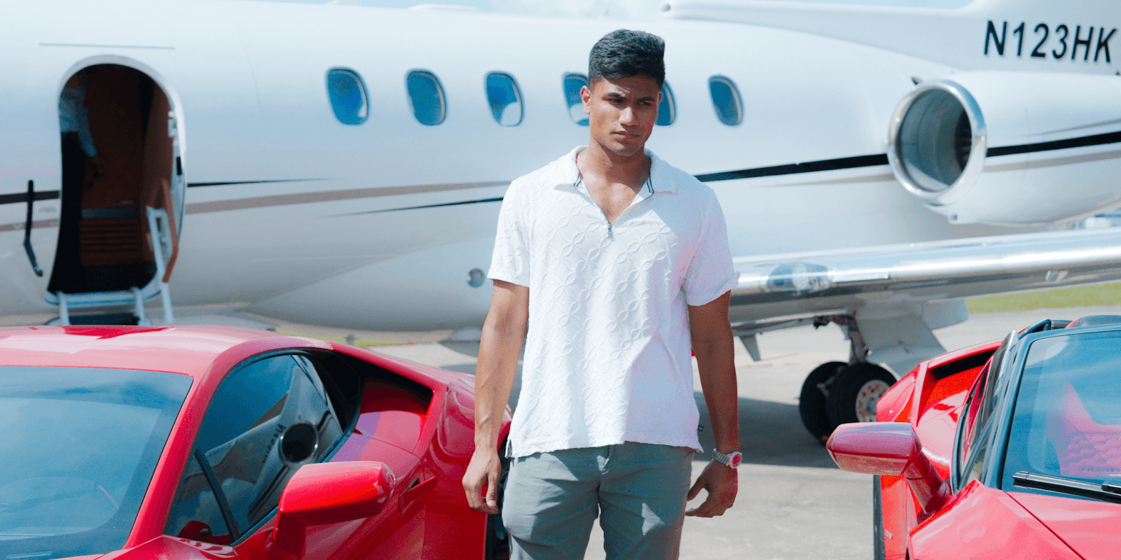 Vadim Barboza with luxury cars and a private jet, embodying iExotic's high-end travel experience.