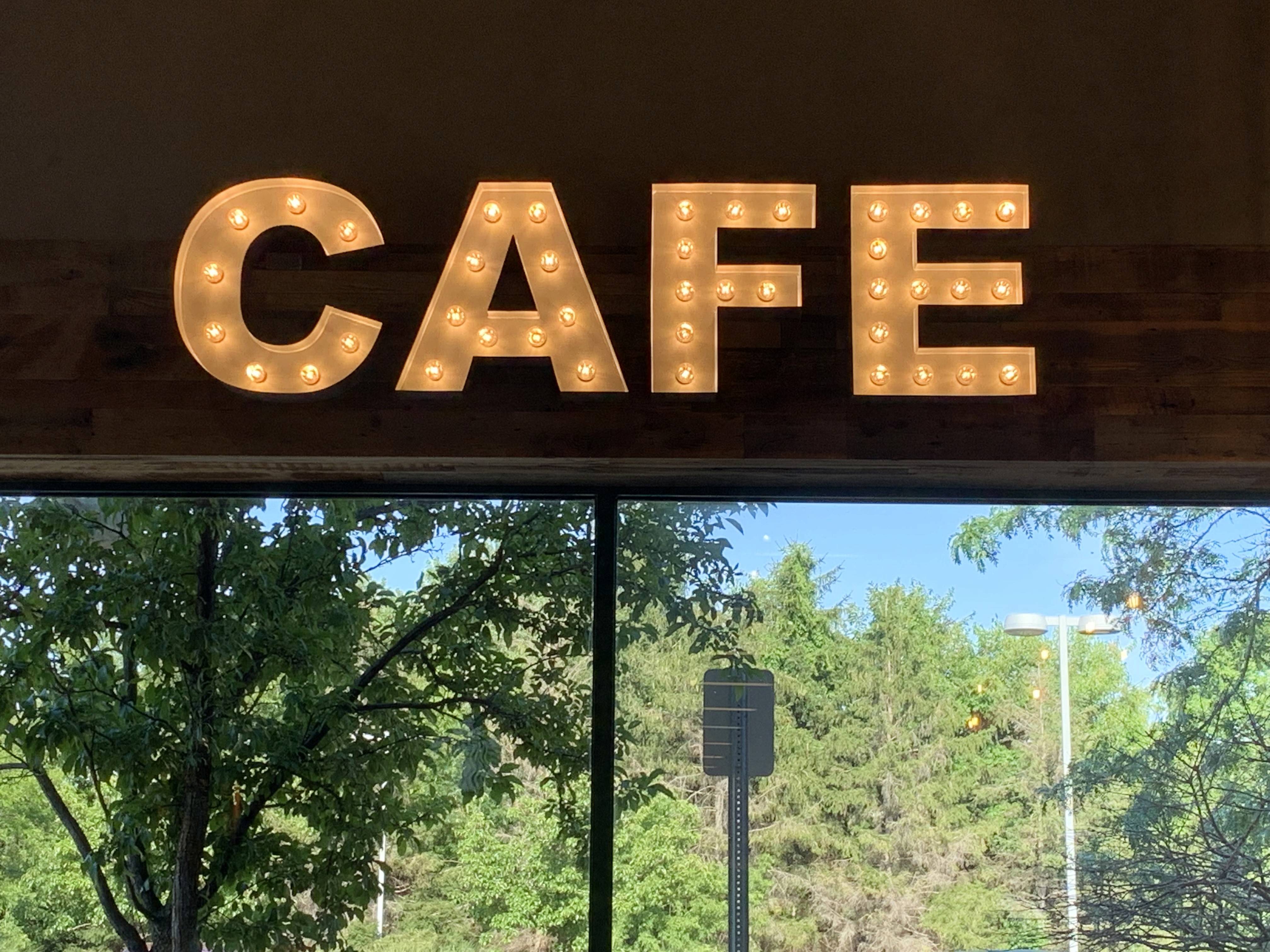 woman sitting around table holding tablet