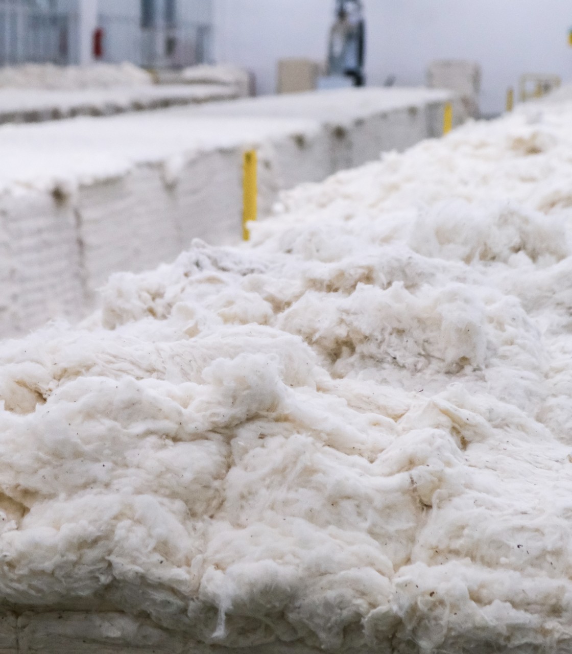Raw cotton fibers prepared for textile material production in factory environment