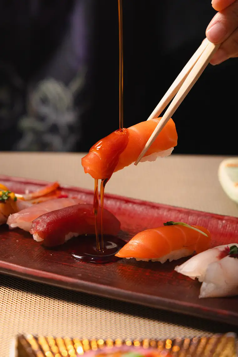 Salmon nigiri dipped in soy sauce