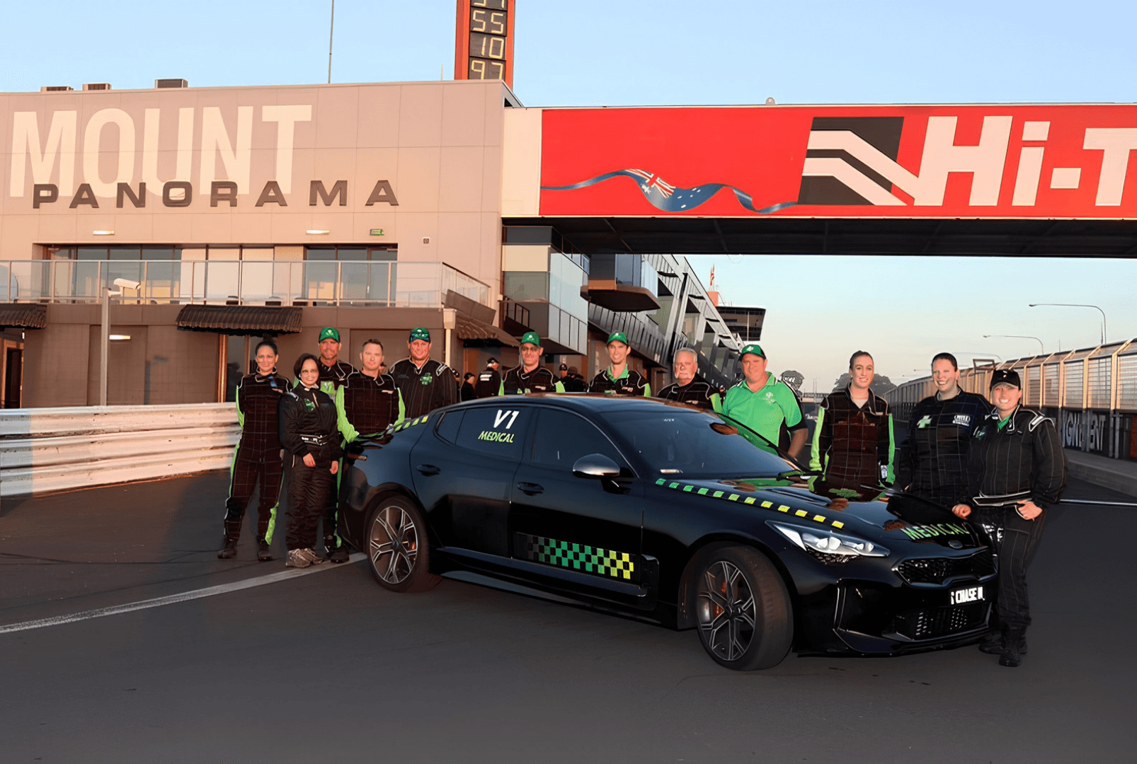 Emergency Logistic Solutions team standing in front of a medical chase car on a racetrack at Bathurst Mount Panorama