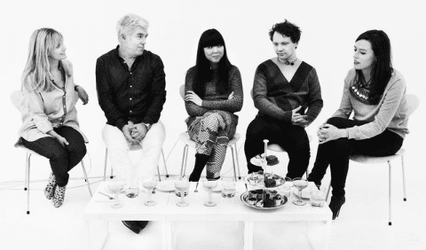 A group of people sitting around a table

AI-generated content may be incorrect.