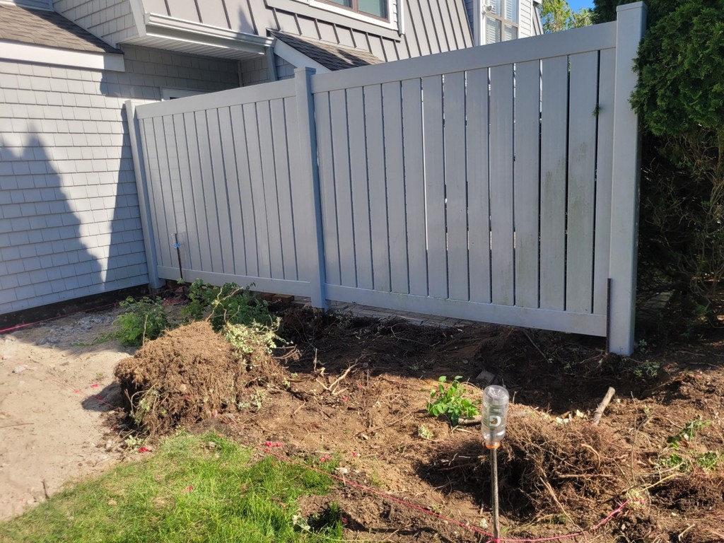 white fencing dividing two houses