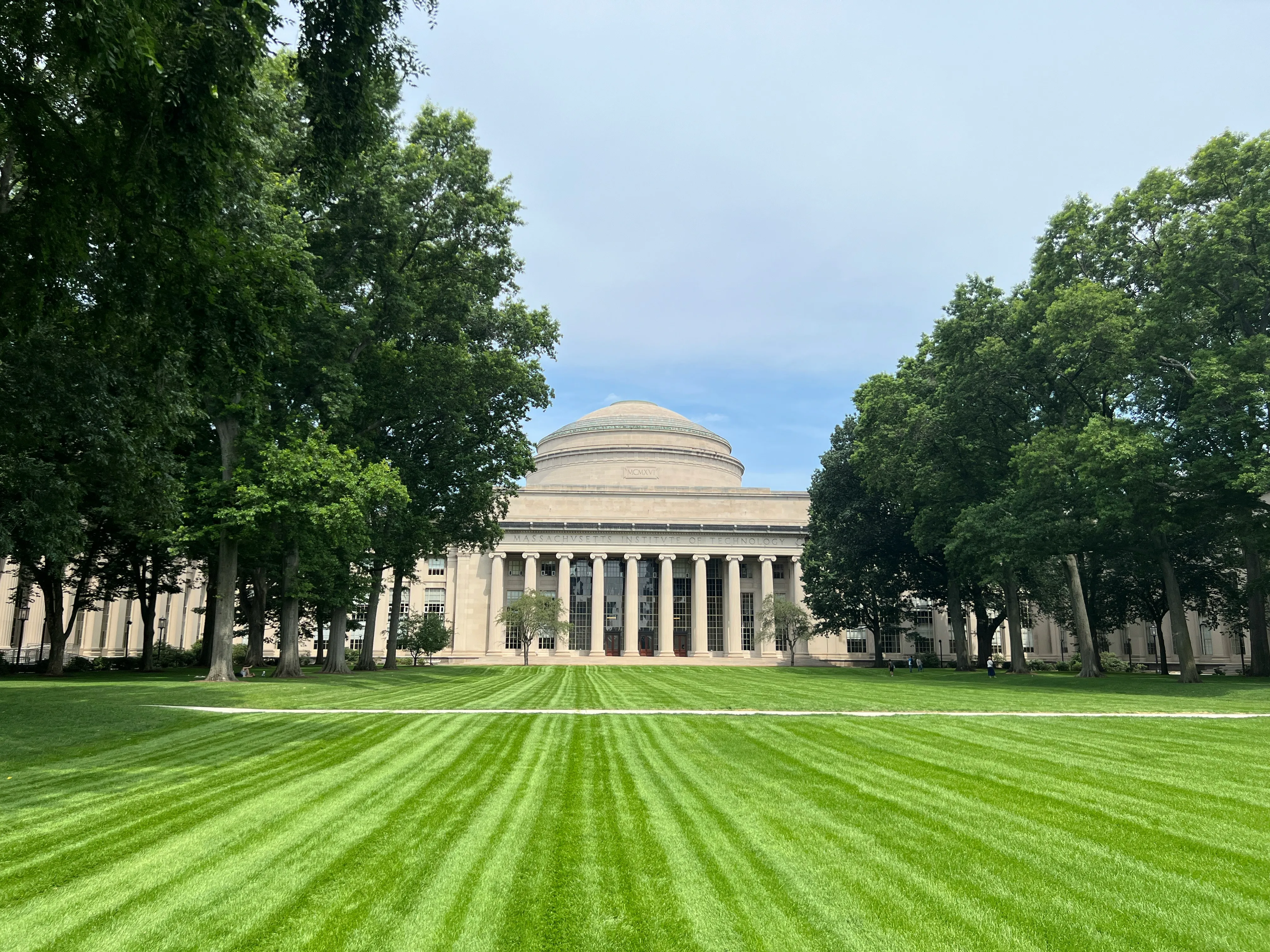 A large grassy field with a building in the background