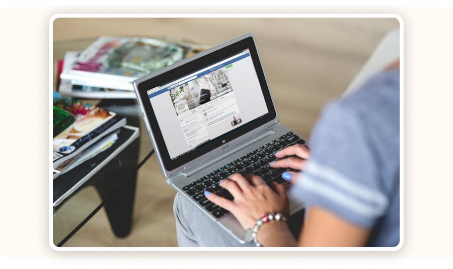 Person using Facebook on laptop