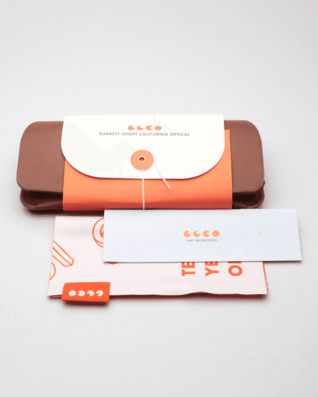 Garrett Leight 10-year anniversary mark applied to branded packaging and campaign collateral including lens cloths and merchandise