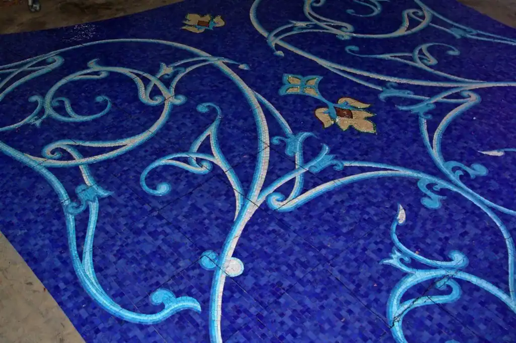 Beautiful mosaic glass pool with intricate blue and gold patterns in Naples Bay.