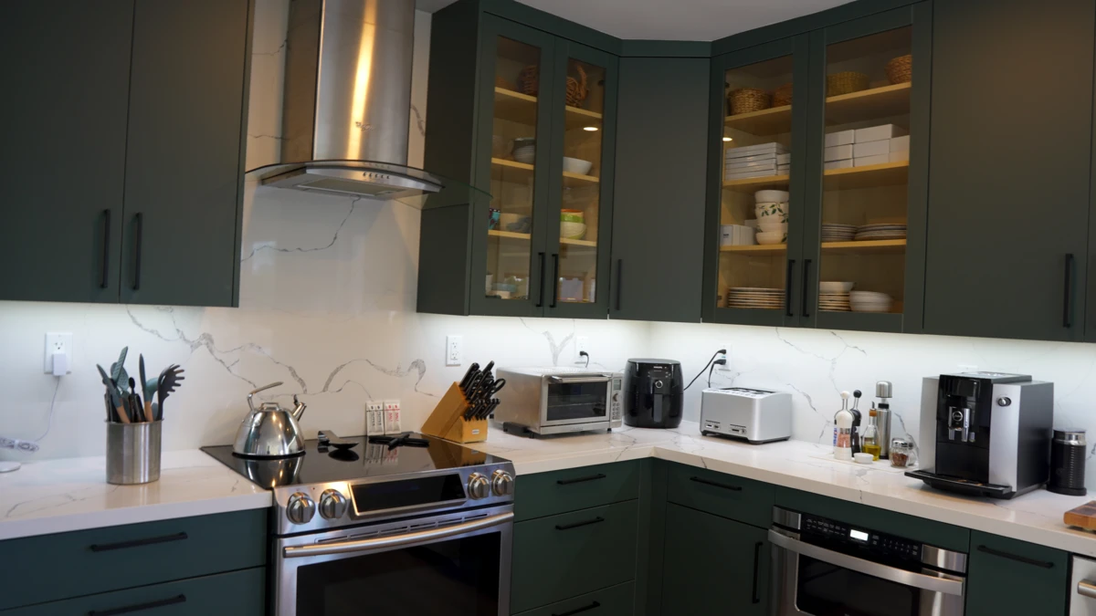 Verde Salvia Kitchen Cabinets with appliances and utilities on top of statuario classique quartz countertop