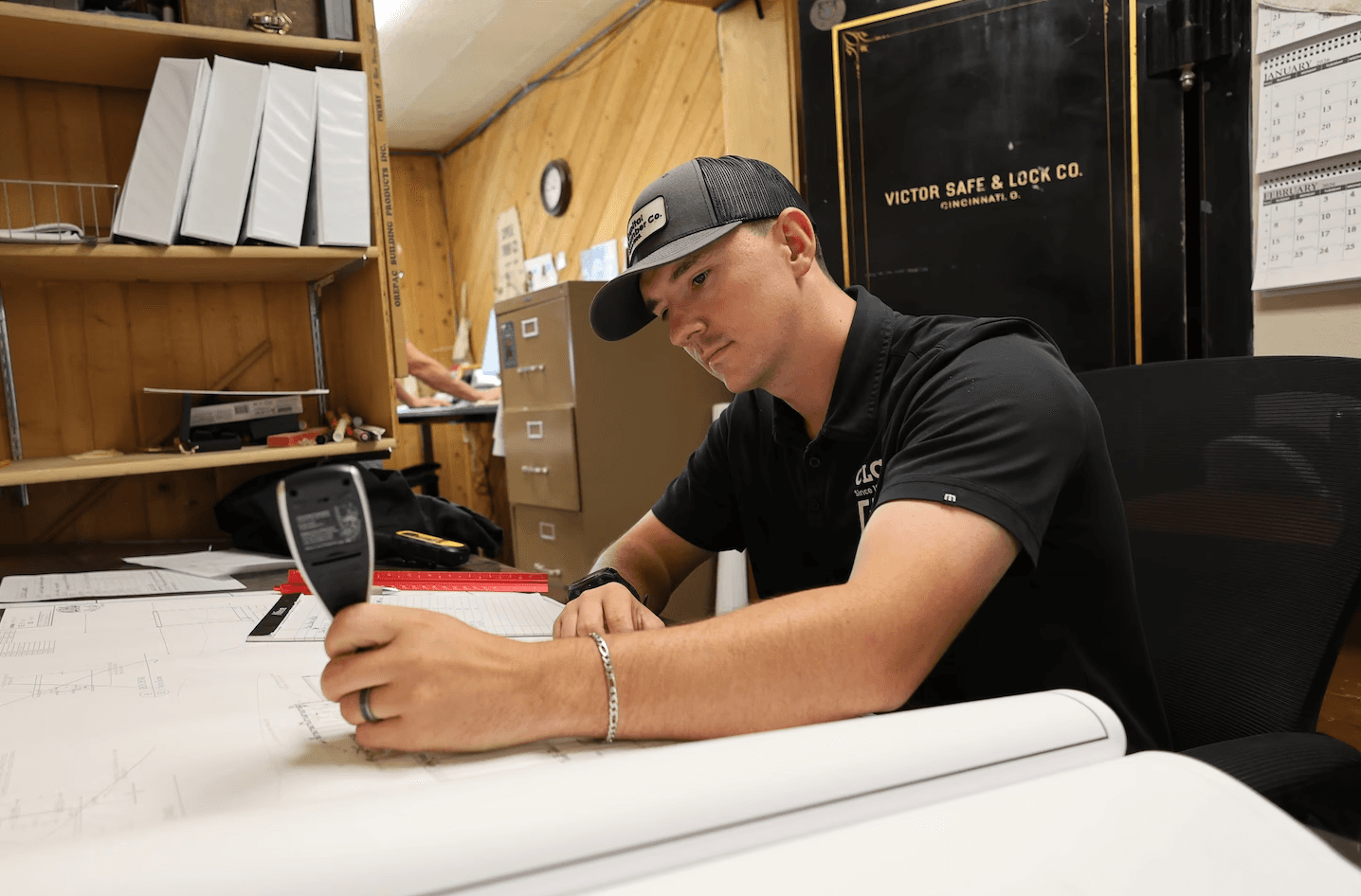 Capital Lumber employee working at the drafting desk