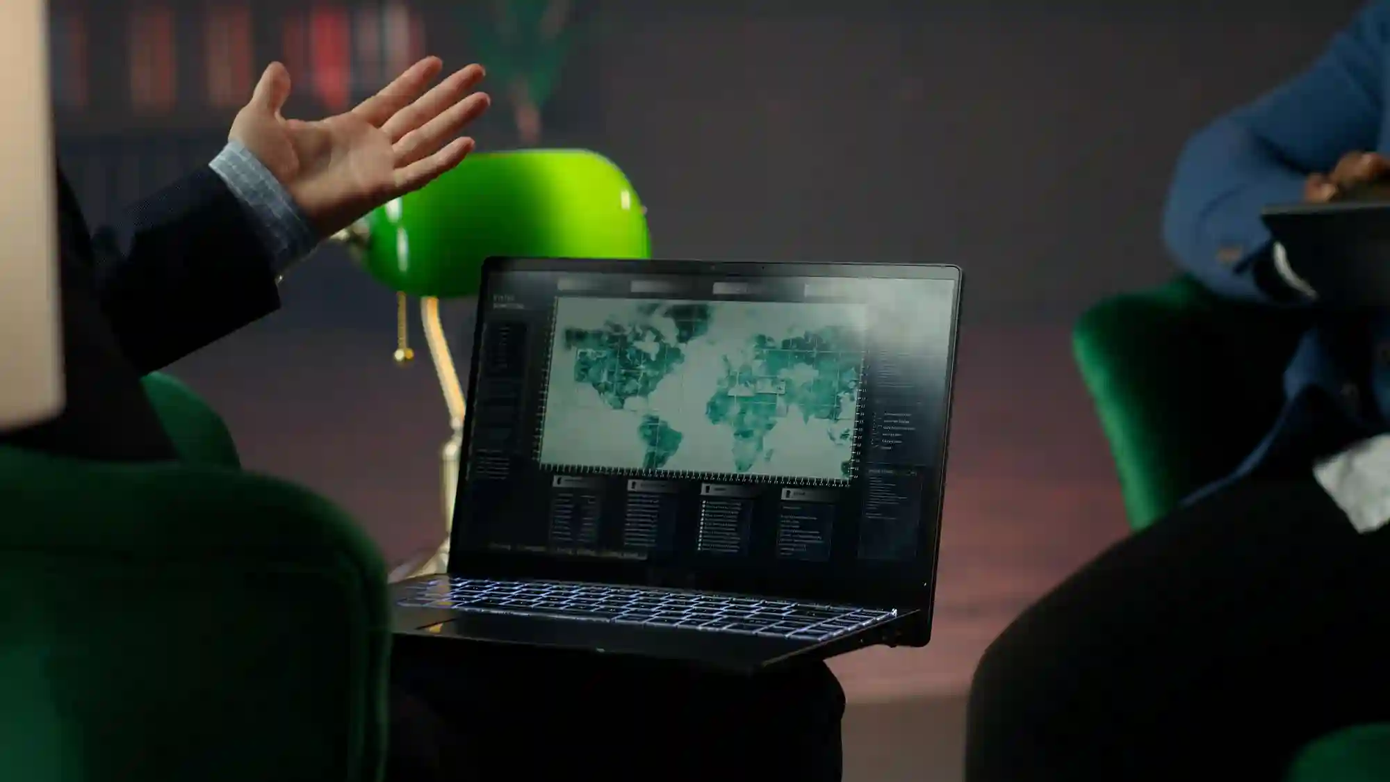 Professionals discussing a global data map on a laptop, highlighting the strategic repositioning of international digital infrastructure.