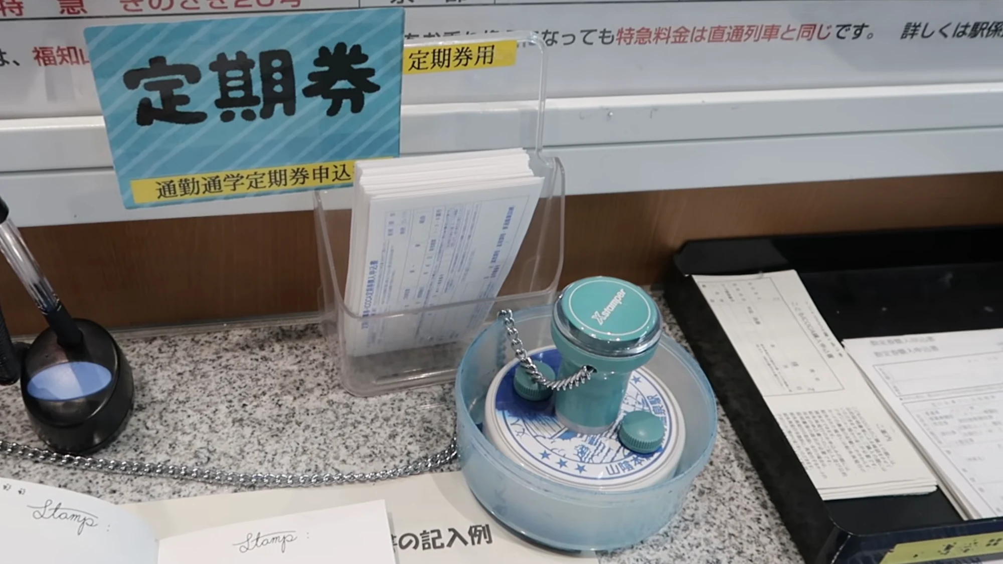 Ticket counter at Kinosaki Onsen station with a board showing the limited express bound for Kyoto.