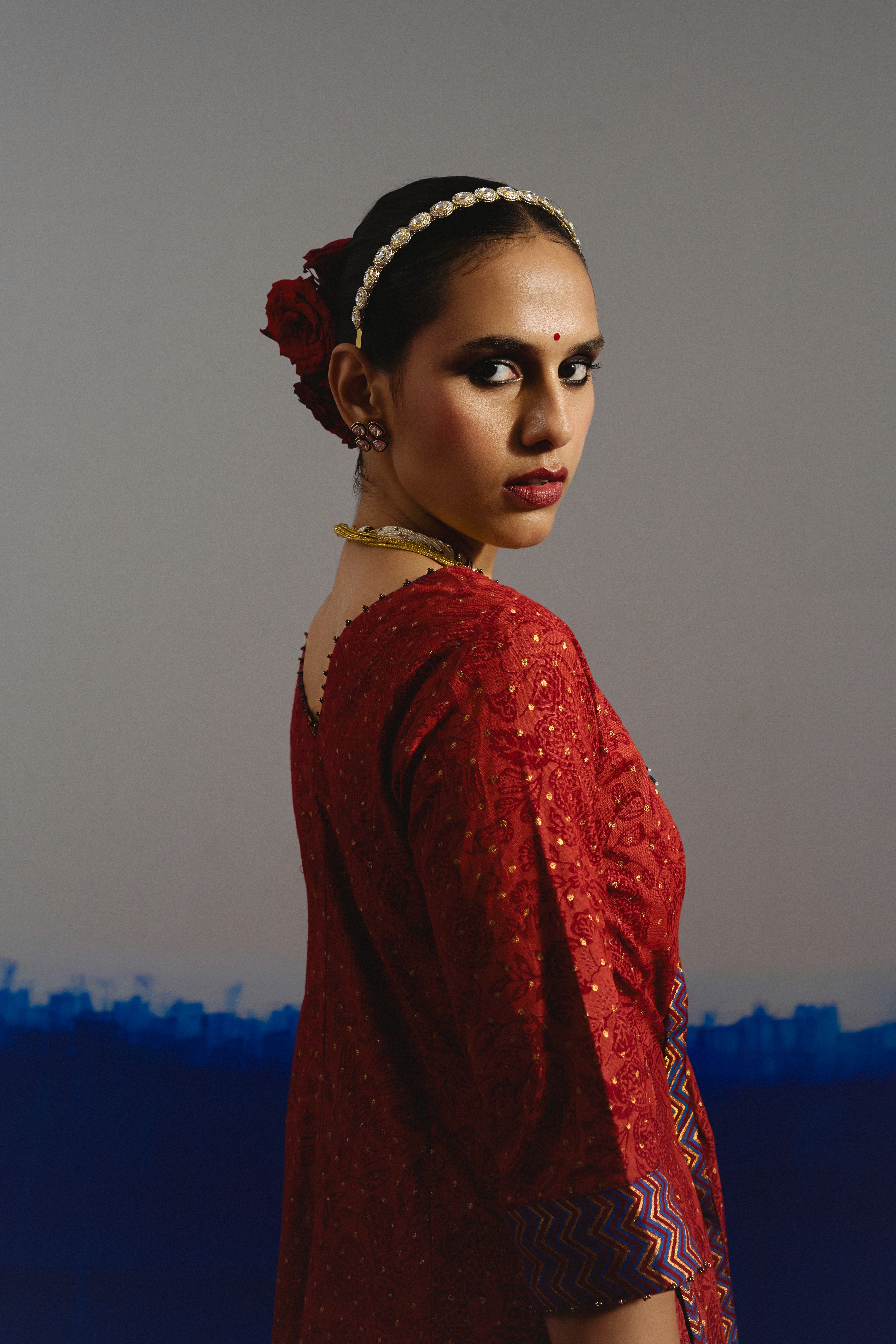 Two people talking on a rooftop at sunset