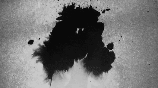 A black and white photo of some liquid mixing with another.