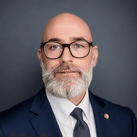 a man wearing glasses and a black shirt