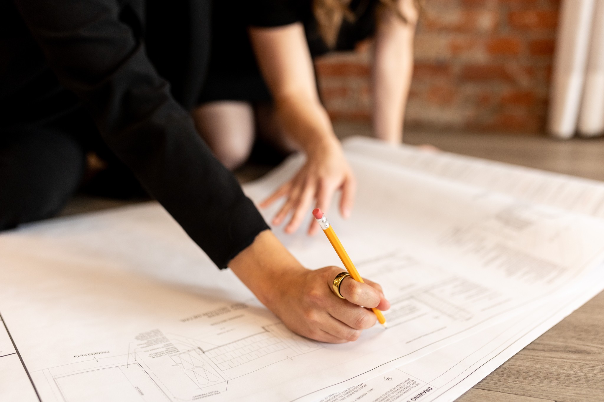 Image of KHD Homes designer working on layout design for home renovations and construction projects with pencil.