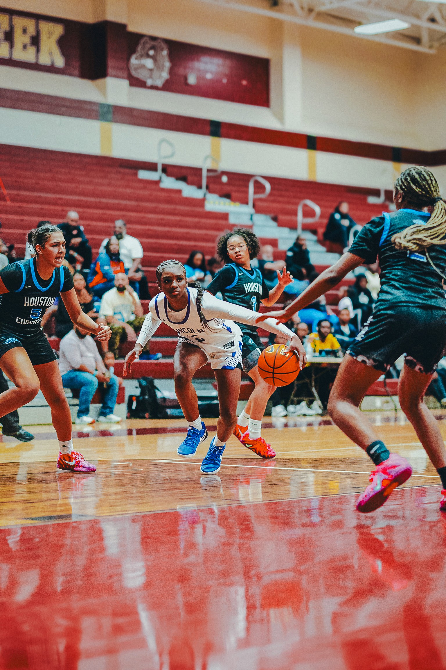 Three people sitting on a couch in a room looking at mobile devices