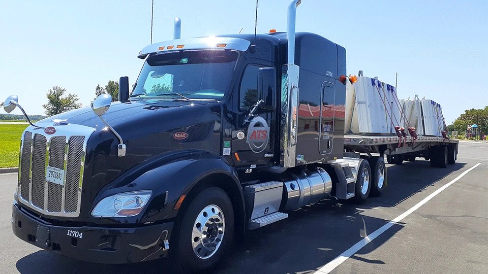 The image presents a serene and modern indoor setting, showing four individuals engrossed in using desktop computers.