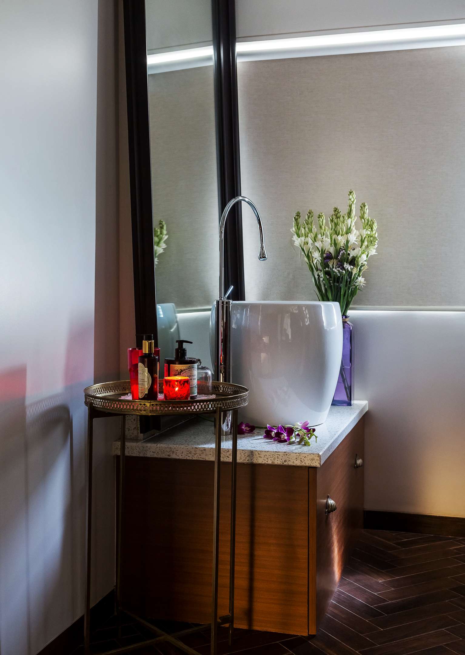 Nature-inspired preschool entrance with sculptural tree partitions and suspended green leaf ceiling panels.