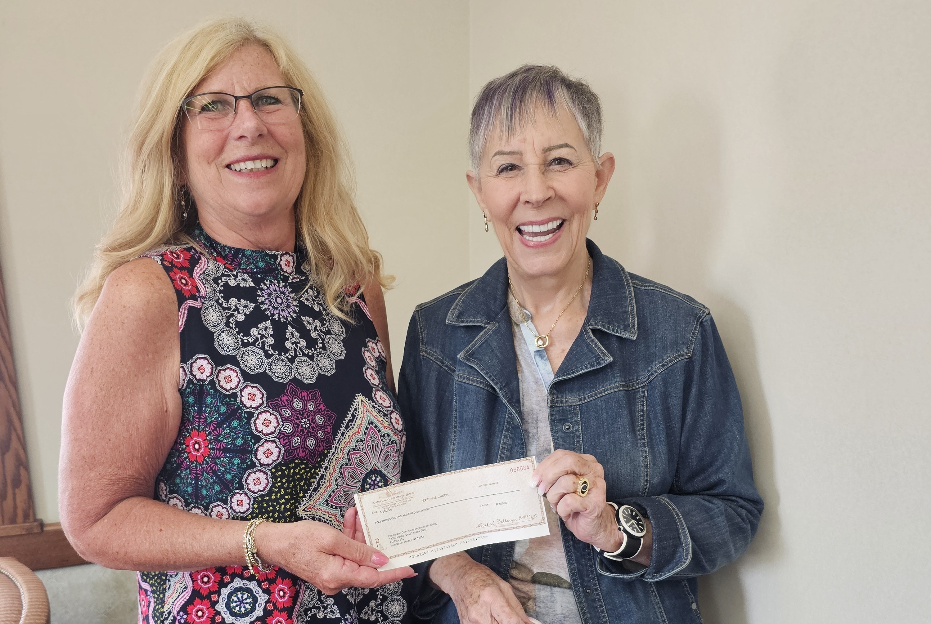 3 members holding a check