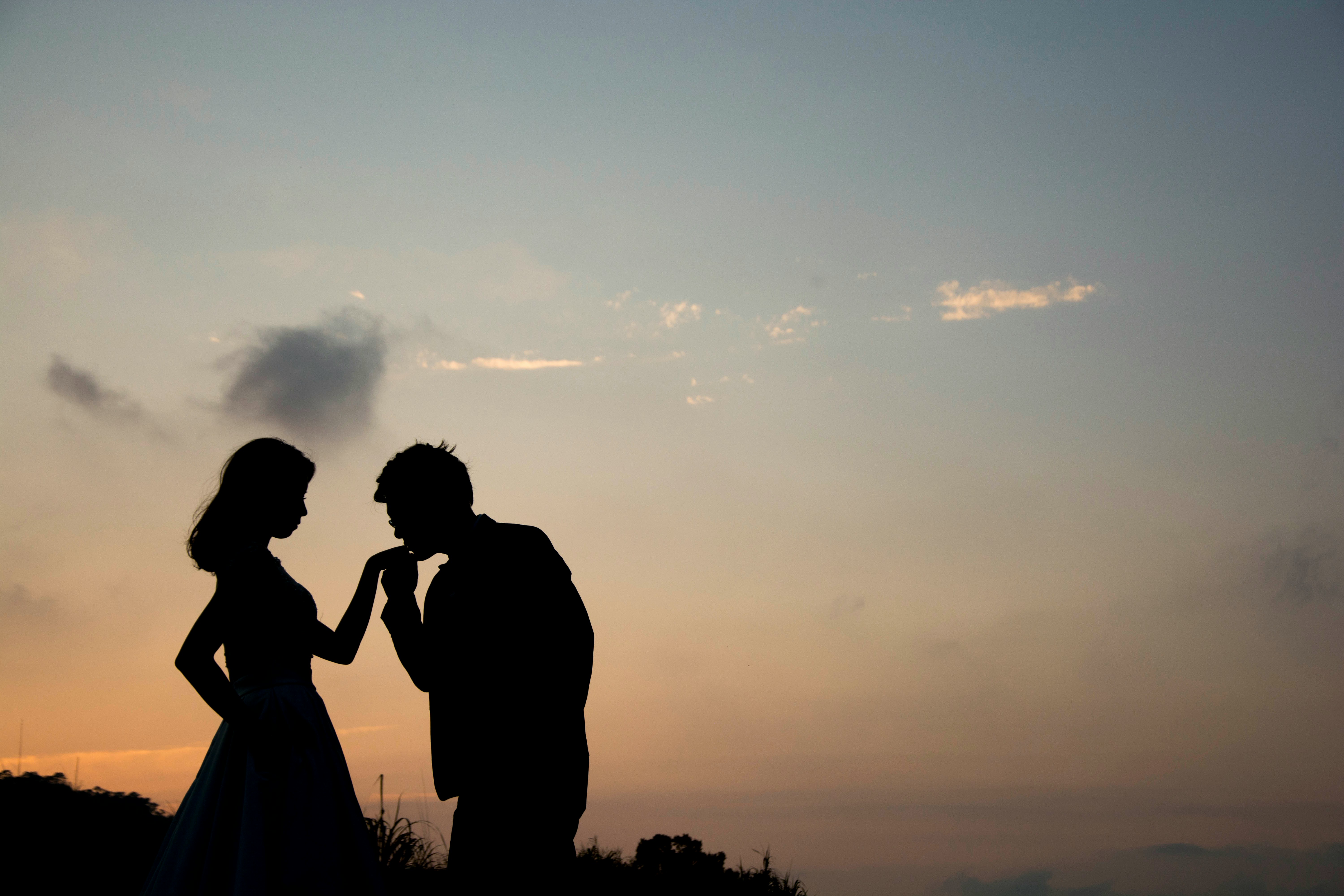 husband kissing his girlfriend on the hand