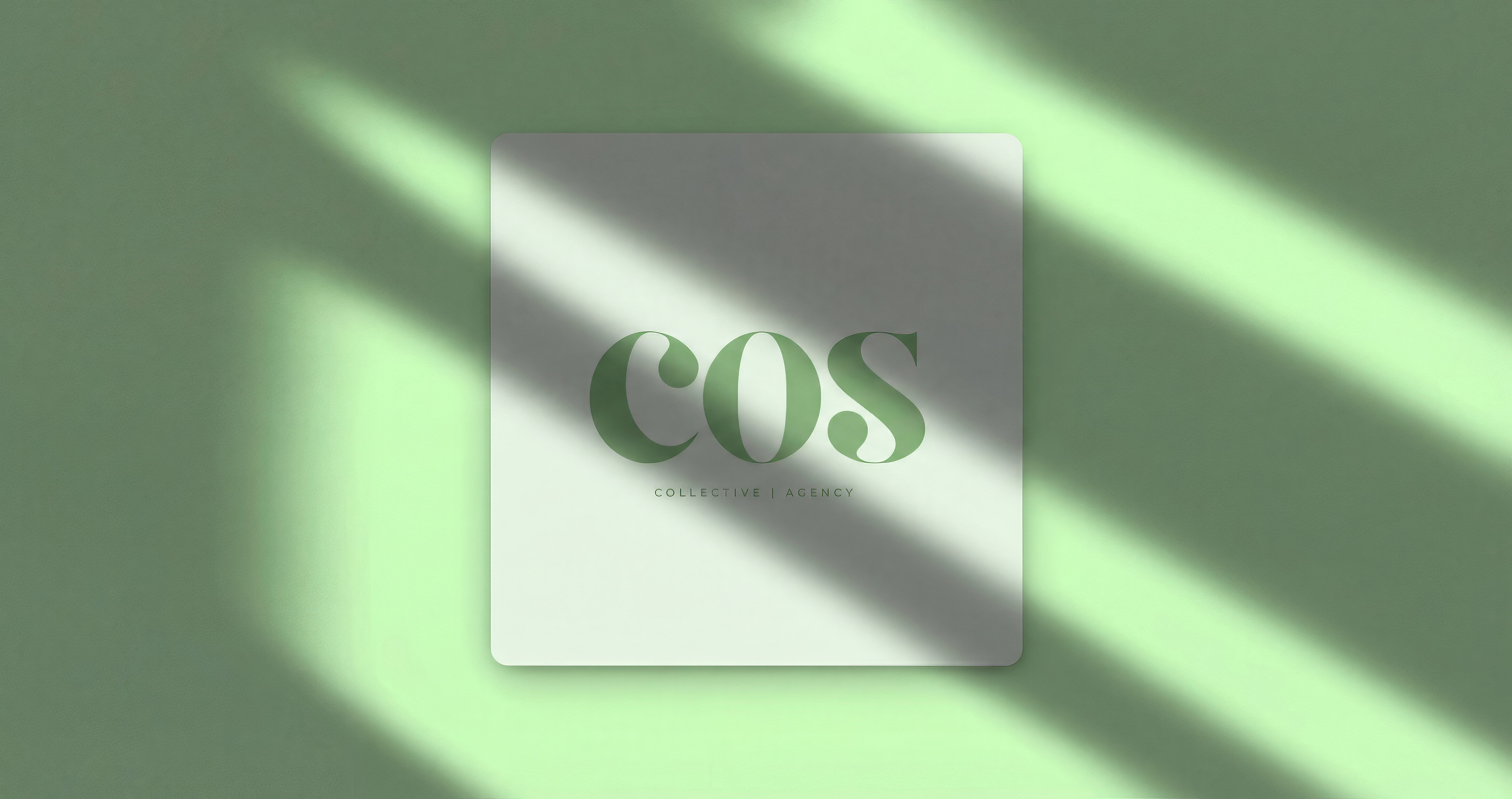 Abstract macro of a glass drop forming a black-and-white flower shape through light refraction on a soft gray background.