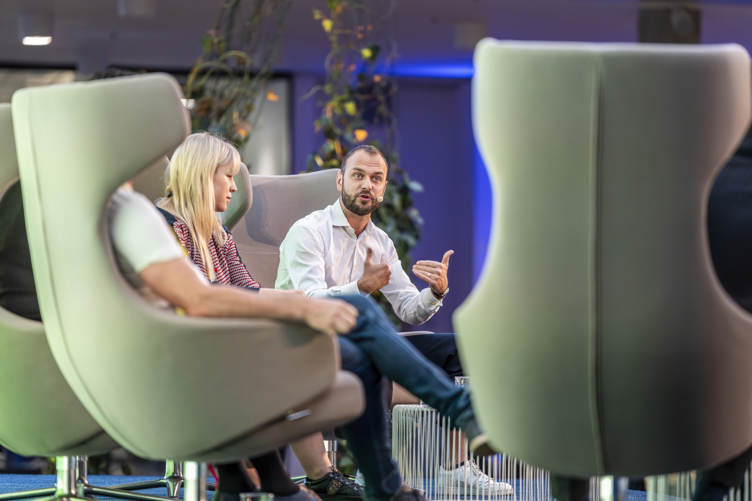 Interview-style discussion on stage during a corporate conference session.