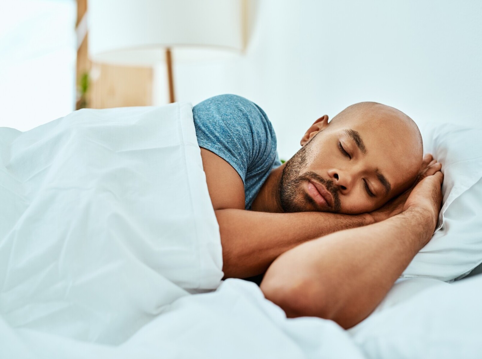 man sleeping in bed at home to support the weight loss walking distance he did the day before