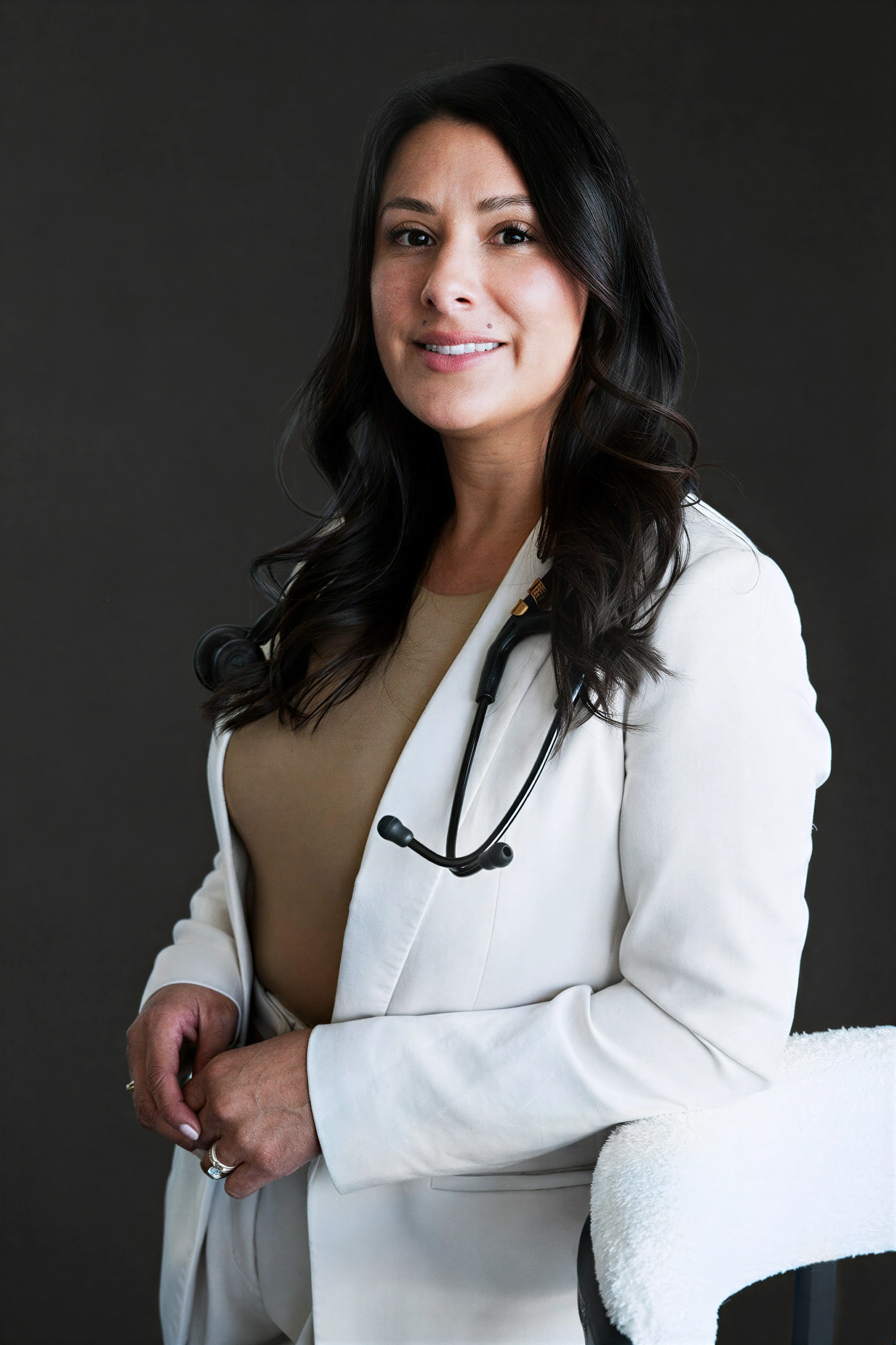 Portrait of Nurse Practitioner Melinda O’Neal smiling outdoors in blue medical scrubs, Meridian Medical Aesthetics.