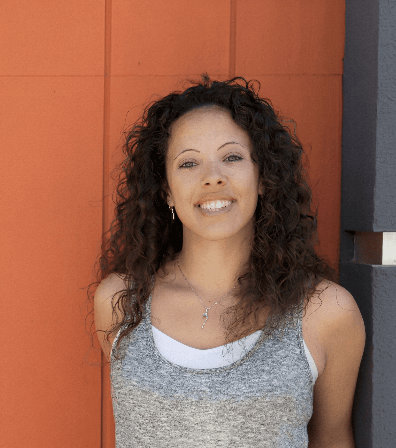 Jeep driving over desert dunes during sunset with warm golden sky.
