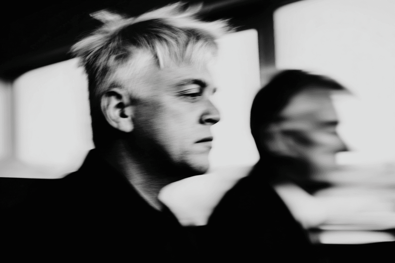 The image features a young woman and man sitting at a table, presumably engaged in a serious discussion or a collaborative task.