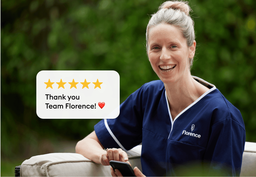 Smiling healthcare worker in navy scrubs holding a phone outdoors with a five-star rating message thanking Team Florence.